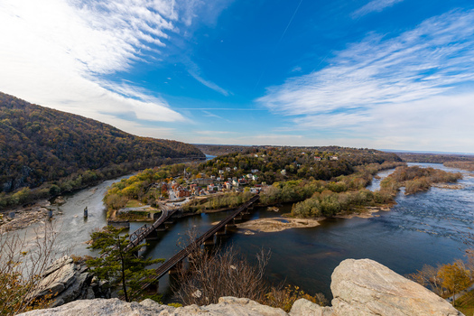 Harpers Ferry West Virginia United States 16 November 2019 Aerial view of the confluence of the Potomac and Shenandoah rivers historic town railway bridges and autumn foliage. Harpers Ferry West Virginia United States 16 November 2019 Aerial view of the confluence of the Potomac and Shenandoah rivers historic town railway bridges and autumn foliage.