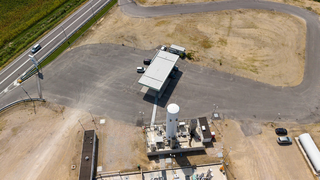 Aerial view of a modern biomethane production facility with a bioCNG and bioLNG fueling station featuring industrial infrastructure and storage tanks in Tavazzano con Villavesco Lombardy Italy.