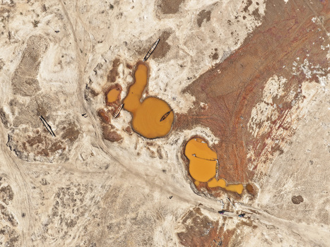 Aerial view of the Jadukata River with small wooden boats resting in orange colored water pools amidst a vast dry sandy riverbed landscape in Sunamganj Sylhet Division Bangladesh. Aerial view of the Jadukata River with small wooden boats resting in orange colored water pools amidst a vast dry sandy riverbed landscape in Sunamganj Sylhet Division Bangladesh.