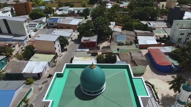 Aerial view of a green mosque dome and urban rooftops Maldives. Aerial view of a green mosque dome and urban rooftops Maldives.