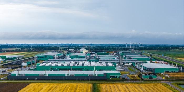 Aerial view of Agriport A7 an industrial complex with green roofed buildings surrounded by agricultural fields and wind turbines in Middenmeer Noord Holland Netherlands. Aerial view of Agriport A7 an industrial complex with green roofed buildings surrounded by agricultural fields and wind turbines in Middenmeer Noord Holland Netherlands.