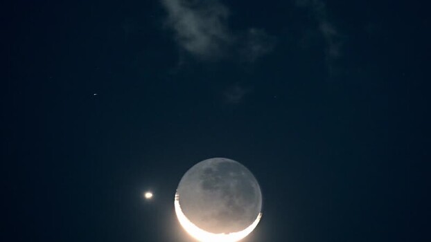 View of the moon in the night sky over Rio de Janeiro Brazil.
