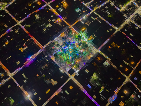 Aerial view of the city s central square bursts with vivid colors against the dark grid of streets and buildings Salamina Caldas Colombia. Aerial view of the city s central square bursts with vivid colors against the dark grid of streets and buildings Salamina Caldas Colombia.