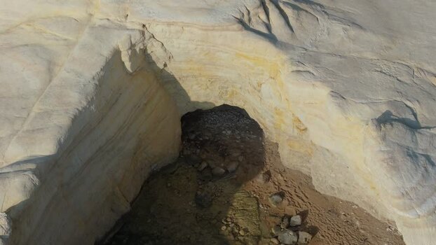 Aerial view of coastal sea cave in white limestone cliffs Cyprus.