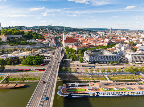Aerial view of St. Martin s Cathedral the SNP Bridge with traffic and a cruise ship on the Danube river in Bratislava Bratislava Region Slovakia. Aerial view of St. Martin s Cathedral the SNP Bridge with traffic and a cruise ship on the Danube river in Bratislava Bratislava Region Slovakia.