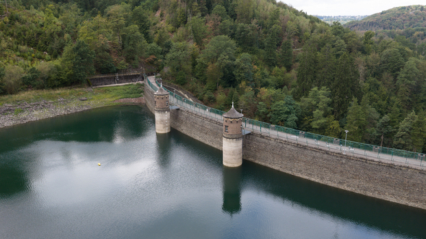 Aerial view of Sengbachtalsperre dam with its stone towers and reservoir surrounded by dense forest in Solingen Nordrhein Westfalen Germany. Aerial view of Sengbachtalsperre dam with its stone towers and reservoir surrounded by dense forest in Solingen Nordrhein Westfalen Germany.