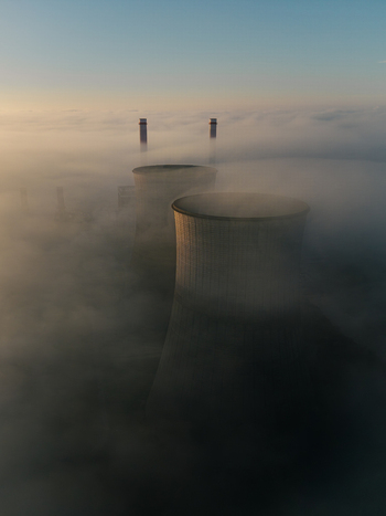Aerial view of RWE Clauscentrale power plant cooling towers and chimneys rising above a thick layer of morning fog Maasbracht Limburg Netherlands. Aerial view of RWE Clauscentrale power plant cooling towers and chimneys rising above a thick layer of morning fog Maasbracht Limburg Netherlands.
