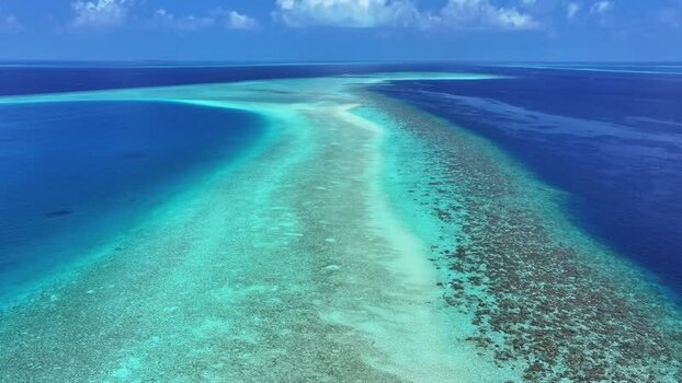 Aerial view of a long coral reef and turquoise lagoon Maldives. Aerial view of a long coral reef and turquoise lagoon Maldives.