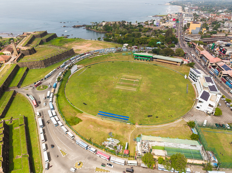 Aerial view of Galle International Stadium and the historic Galle Fort walls next to the Indian Ocean coastline in Galle Southern Province Sri Lanka. Aerial view of Galle International Stadium and the historic Galle Fort walls next to the Indian Ocean coastline in Galle Southern Province Sri Lanka.