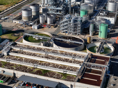 Aerial view of the chemical plant industrial facility featuring large circular settling tanks and aeration basins Crescentino Piedmont Italy.