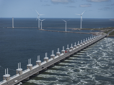 Aerial view of the Eastern Scheldt Storm Surge Barrier with wind turbines and turbulent water in Vrouwenpolder Zeeland Netherlands. Aerial view of the Eastern Scheldt Storm Surge Barrier with wind turbines and turbulent water in Vrouwenpolder Zeeland Netherlands.