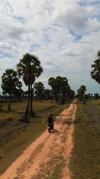 Aerial view of a dirt road with a motorcycle in Cambodia. Aerial view of a dirt road with a motorcycle in Cambodia.