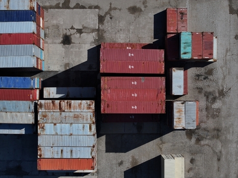 Aerial view of colorful shipping containers stacked in a logistics terminal on a concrete surface Cincinnati OH United States.