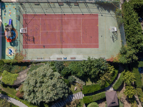 Aerial view of a tennis court and playground surrounded by lush greenery and trees in Istanbul Istanbul Turkiye. Aerial view of a tennis court and playground surrounded by lush greenery and trees in Istanbul Istanbul Turkiye.