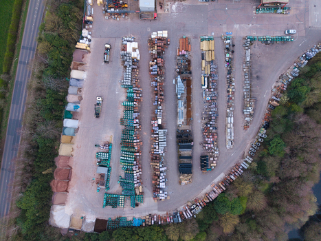 Aerial view of an industrial landscape where neatly arranged stacks of building materials create a textured mosaic of color and form Stafford England United Kingdom. Aerial view of an industrial landscape where neatly arranged stacks of building materials create a textured mosaic of color and form Stafford England United Kingdom.