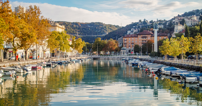 Rijeka Croatia 19 September 2026 View of Mrtvi Kanal canal with small boats moored along stone embankments surrounded by autumn trees and historic buildings. Rijeka Croatia 19 September 2026 View of Mrtvi Kanal canal with small boats moored along stone embankments surrounded by autumn trees and historic buildings.