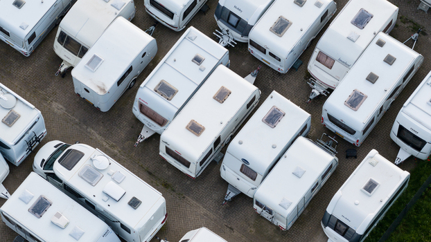 Purmerend Netherlands 15 June 2026 Aerial view of numerous white caravans parked in neat rows on a paved lot showcasing organized storage for recreational vehicles. Purmerend Netherlands 15 June 2026 Aerial view of numerous white caravans parked in neat rows on a paved lot showcasing organized storage for recreational vehicles.