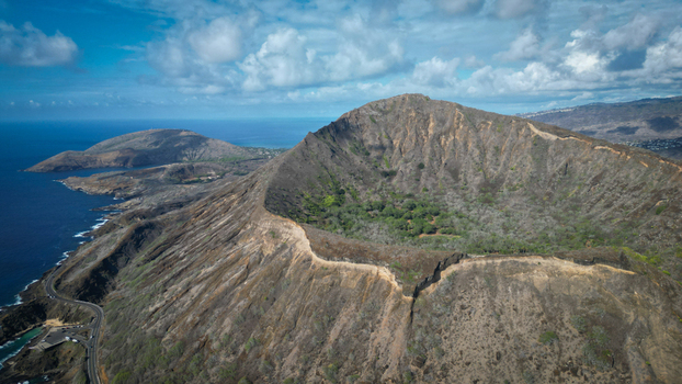 Aerial view of the rugged sun baked Koko Head volcano crater contrasts with the deep blue of the Pacific a stark reminder of nature s power Honolulu Hawaii United States. Aerial view of the rugged sun baked Koko Head volcano crater contrasts with the deep blue of the Pacific a stark reminder of nature s power Honolulu Hawaii United States.