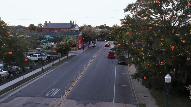 Aerial view of a street in Conway decorated with festive pumpkin lights in the trees during the evening in Conway South Carolina United States. Aerial view of a street in Conway decorated with festive pumpkin lights in the trees during the evening in Conway South Carolina United States.