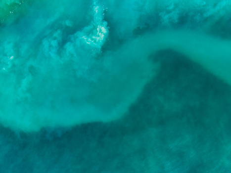 Aerial view of the swirling turquoise waters meeting in a mesmerizing dance of currents and hues Kadrihnitin Socotra Yemen. Aerial view of the swirling turquoise waters meeting in a mesmerizing dance of currents and hues Kadrihnitin Socotra Yemen.