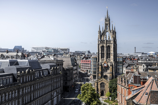 Aerial view of Newcastle Cathedral surrounded by historic stone buildings and urban rooftops in Newcastle upon Tyne England United Kingdom. Aerial view of Newcastle Cathedral surrounded by historic stone buildings and urban rooftops in Newcastle upon Tyne England United Kingdom.