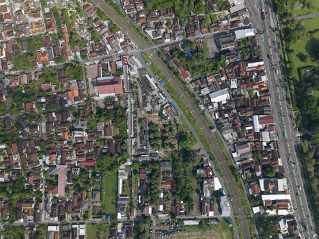 Aerial view of Animal Market Prambanan with dense residential rooftops narrow streets and lush green trees in Kecamatan Prambanan Jawa Tengah Indonesia. Aerial view of Animal Market Prambanan with dense residential rooftops narrow streets and lush green trees in Kecamatan Prambanan Jawa Tengah Indonesia.