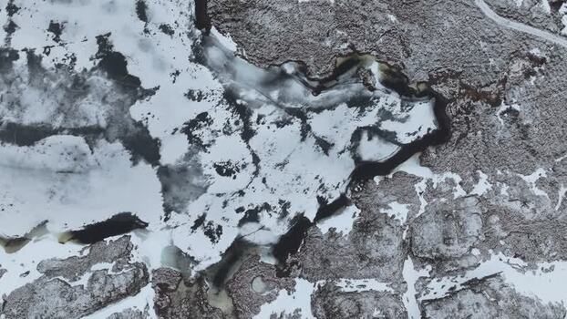 Aerial view of snowy rocky terrain in Lofoten Norway.