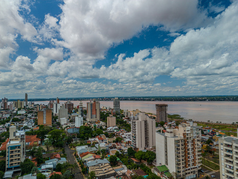 Aerial view of the cityscape of Posadas with high rise buildings and residential areas along the banks of the Parana River in Posadas Misiones Province Argentina. Aerial view of the cityscape of Posadas with high rise buildings and residential areas along the banks of the Parana River in Posadas Misiones Province Argentina.