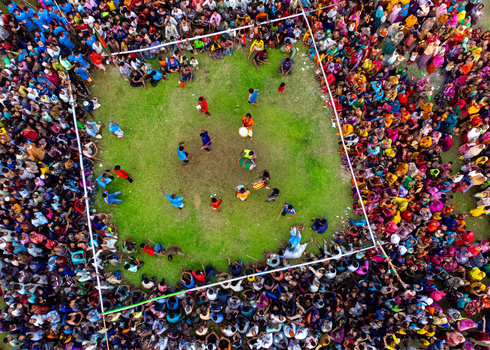Nilphamari Bangladesh 01 May 2026 Aerial view of a large crowd gathered around a square green field for a traditional festival or sporting event. Nilphamari Bangladesh 01 May 2026 Aerial view of a large crowd gathered around a square green field for a traditional festival or sporting event.