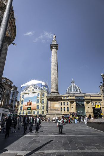 Newcastle upon Tyne England United Kingdom 13 July 2026 View of Grey s Monument surrounded by historic buildings shops and people walking in the square under a clear blue sky. Newcastle upon Tyne England United Kingdom 13 July 2026 View of Grey s Monument surrounded by historic buildings shops and people walking in the square under a clear blue sky.