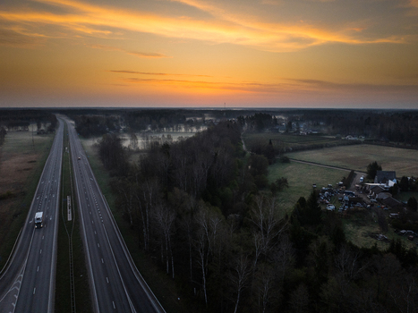 Aerial view of the intersection of A5 and A8 highways surrounded by forests and fields at sunset in Olaine Parish Olaine Municipality Latvia. Aerial view of the intersection of A5 and A8 highways surrounded by forests and fields at sunset in Olaine Parish Olaine Municipality Latvia.