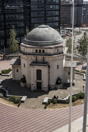 Aerial view of the Hall of Memory a historic war memorial building with a stone dome surrounded by paved plaza areas and modern urban architecture in Birmingham England United Kingdom.