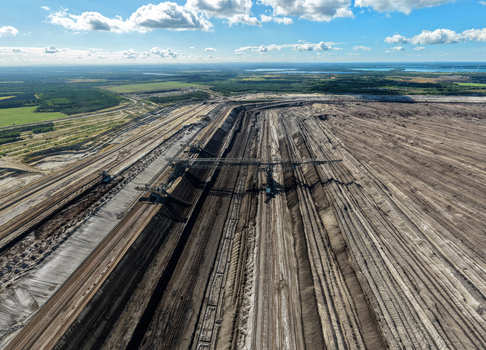 Aerial view of Tagebau Welzow Sud brown coal open pit mine showing excavation layers industrial machinery and surrounding landscape in Spremberg Brandenburg Germany. Aerial view of Tagebau Welzow Sud brown coal open pit mine showing excavation layers industrial machinery and surrounding landscape in Spremberg Brandenburg Germany.