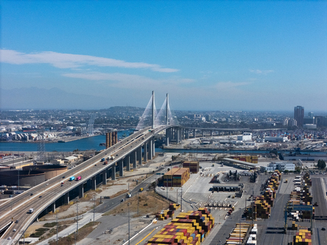 Aerial view of the Gerald Desmond Bridge at the Port of Long Beach with shipping containers and highway traffic in Long Beach California United States. Aerial view of the Gerald Desmond Bridge at the Port of Long Beach with shipping containers and highway traffic in Long Beach California United States.