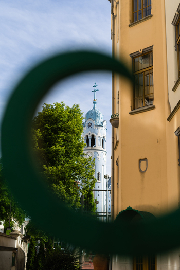 View of the Blue Church with its distinctive light blue tower and facade framed through a circular green element in Bratislava Bratislava Region Slovakia. View of the Blue Church with its distinctive light blue tower and facade framed through a circular green element in Bratislava Bratislava Region Slovakia.