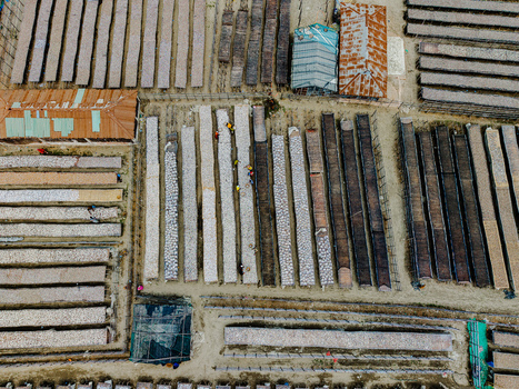 Cox s Bazar Bangladesh 11 March 2026 Aerial view of a traditional fish drying yard with workers tending to long rows of fish on racks. Cox s Bazar Bangladesh 11 March 2026 Aerial view of a traditional fish drying yard with workers tending to long rows of fish on racks.