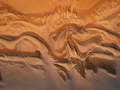 Aerial view of the intricate sand patterns and golden dunes of Two Peoples Bay Nature Reserve with flowing ridges and textured ripples in Albany Western Australia Australia.