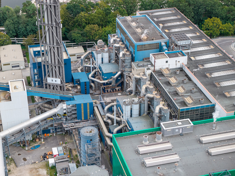 Aerial view of the Klarwerk Ruhleben sewage treatment plant with industrial infrastructure complex piping and large rooftops surrounded by greenery in Berlin Berlin Germany.