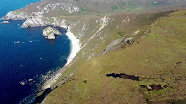 Aerial view of Glenlough Bay cliffs and beach Ireland.