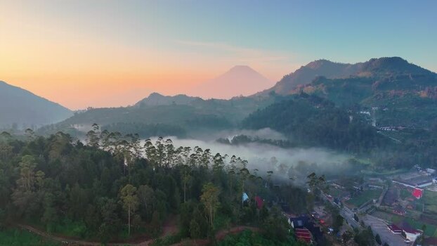 Aerial view of misty mountains and lush green hills Indonesia. Aerial view of misty mountains and lush green hills Indonesia.