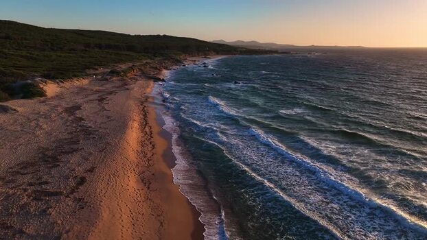 Aerial view of the sandy beach and waves at sunset in Italy. Aerial view of the sandy beach and waves at sunset in Italy.