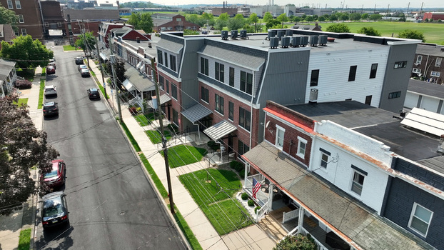 Aerial view of a modern apartment building and traditional row houses along a residential street in Lancaster Pennsylvania United States.