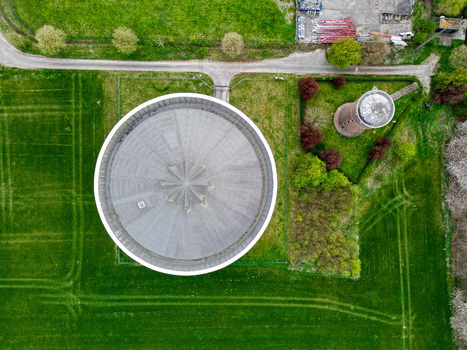 Aerial view of a water tower casting a stark shadow on the verdant field a symphony of rural serenity Ath Wallonia Belgium. Aerial view of a water tower casting a stark shadow on the verdant field a symphony of rural serenity Ath Wallonia Belgium.