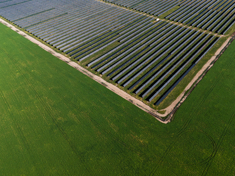 Aerial view of Limondale Solar Farm with rows of solar panels adjacent to green fields Balranald New South Wales Australia. Aerial view of Limondale Solar Farm with rows of solar panels adjacent to green fields Balranald New South Wales Australia.