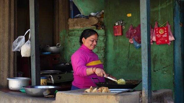 View of a woman cooking in a local kitchen Nepal. View of a woman cooking in a local kitchen Nepal.
