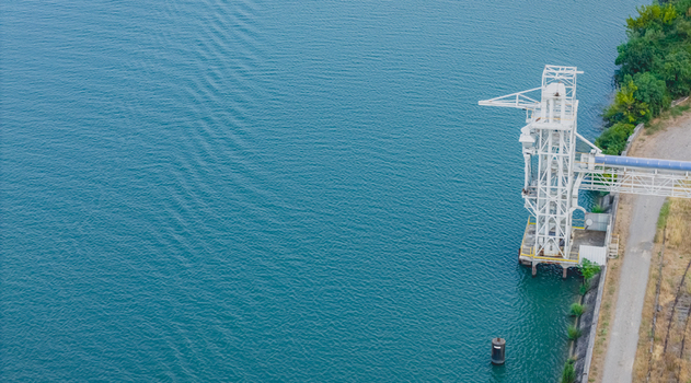 Aerial view of an industrial bulk loading tower with an enclosed conveyor system on the Rhone River in Le Pouzin Auvergne Rhone Alpes France.