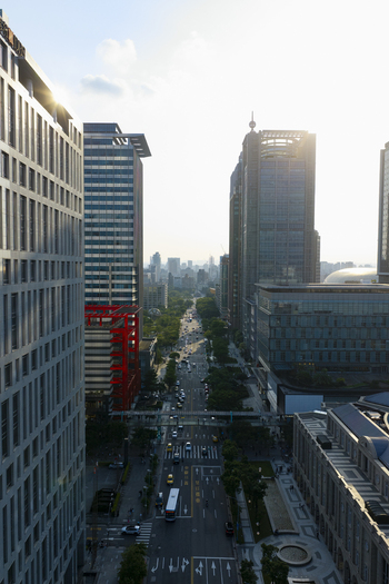 Aerial view of modern skyscrapers lining a busy street with traffic and lush trees in Taipei Taiwan. Aerial view of modern skyscrapers lining a busy street with traffic and lush trees in Taipei Taiwan.