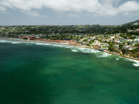 Aerial view of La Jolla Cove featuring turquoise ocean water waves crashing on the sandy beach and coastal buildings in San Diego California United States. Aerial view of La Jolla Cove featuring turquoise ocean water waves crashing on the sandy beach and coastal buildings in San Diego California United States.