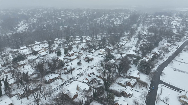 Aerial view of a residential neighborhood in Lynchburg covered in a blanket of fresh snow with bare trees and quiet streets in Lynchburg Virginia United States.