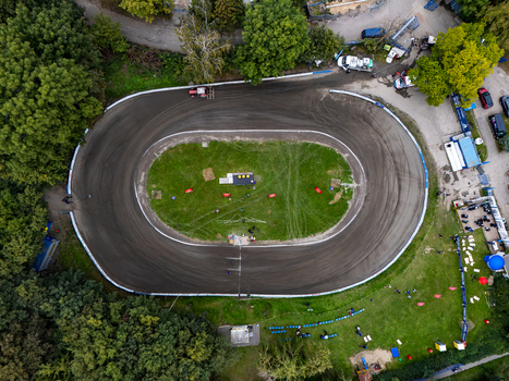 Gdansk Poland 19 September 2026 Aerial view of a speedway track surrounded by lush green trees and grass with a dirt oval circuit and spectators gathered around the perimeter. Gdansk Poland 19 September 2026 Aerial view of a speedway track surrounded by lush green trees and grass with a dirt oval circuit and spectators gathered around the perimeter.